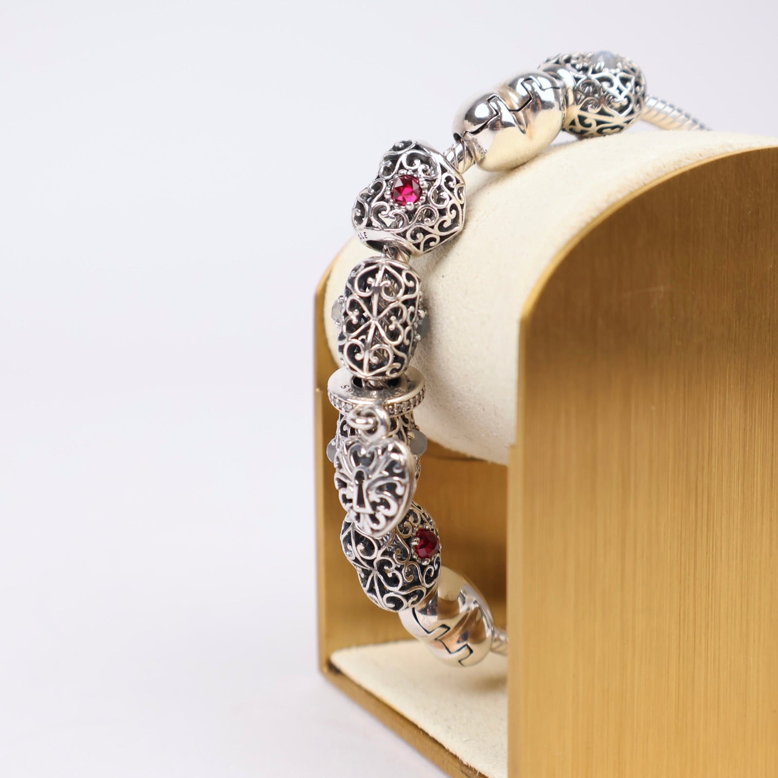 J1303 Pandora Moments Sterling Silver Bracelet with Filigree Heart and Sparkling Red Charms- Pre Owned