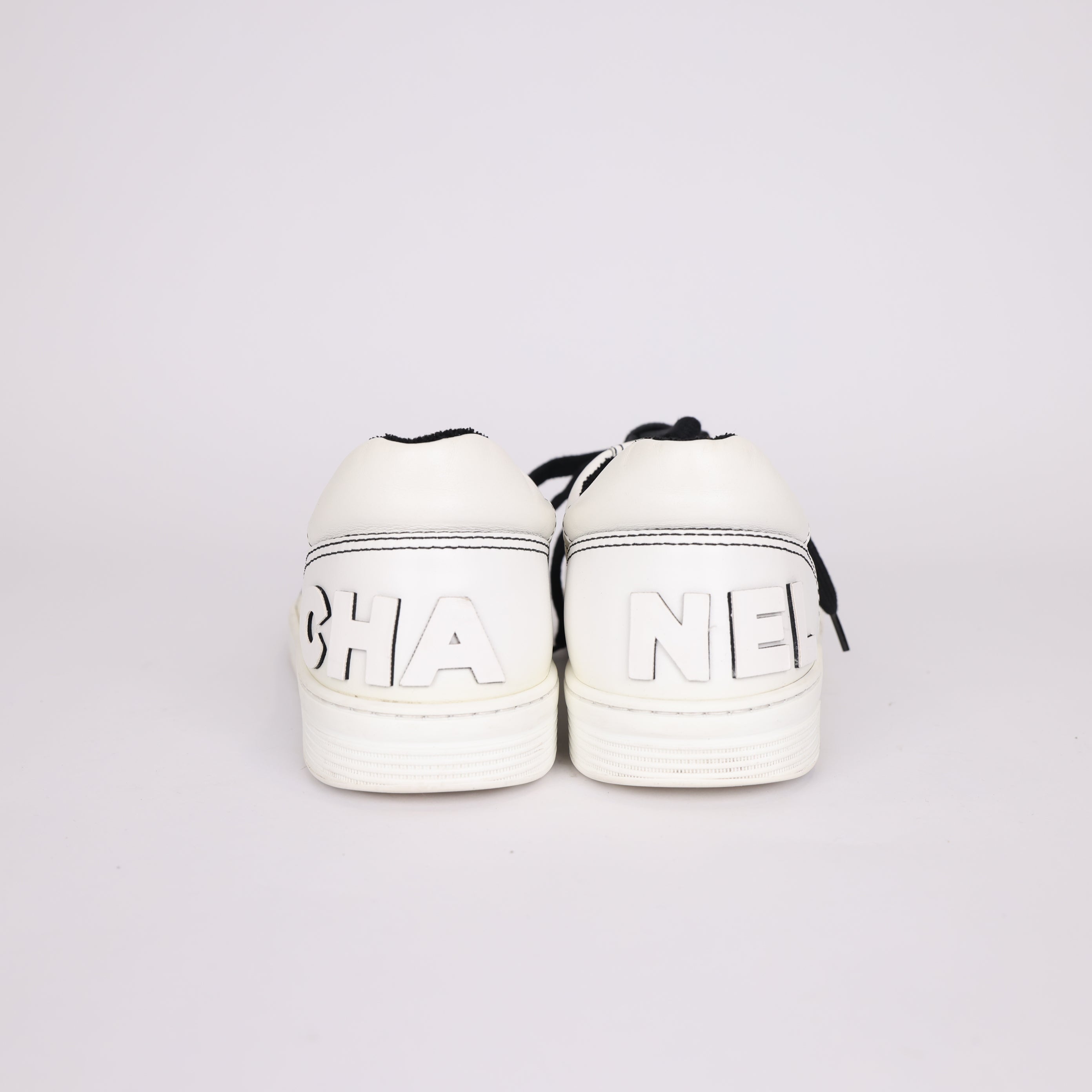 PRE OWNED- Chanel black and white embossed logo sneakers MEN'S size EU41/ UK7 J0503S55521