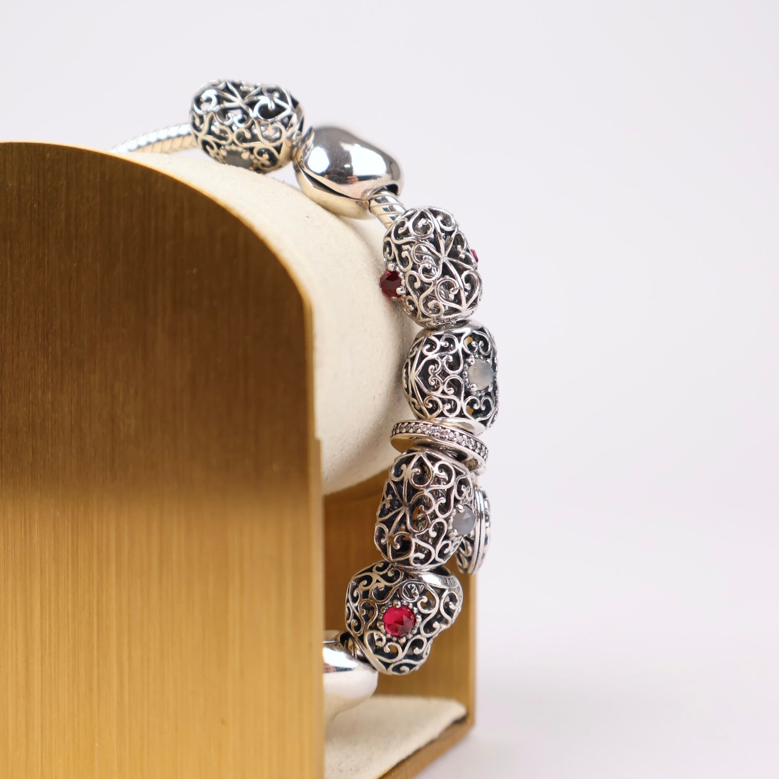 J1303 Pandora Moments Sterling Silver Bracelet with Filigree Heart and Sparkling Red Charms- Pre Owned